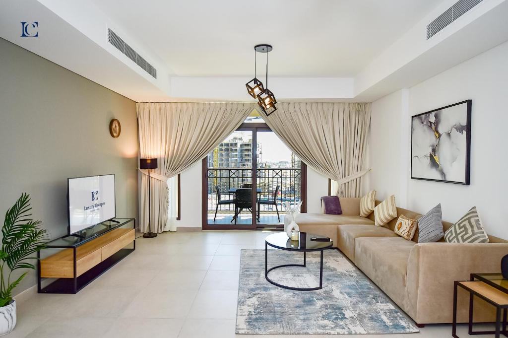 a living room with a couch and a table at Contemporary 2BR Gem in Madinat Jumeirah - RAH in Dubai