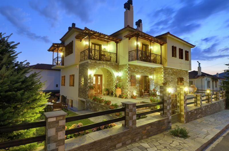 a large house with a fence in front of it at Iatrou Guesthouse in Portariá