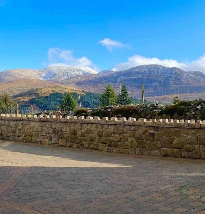 una pared de piedra con montañas en el fondo en Mountainview lodge With Hot tub/ Mancave/Pool room en Kilcoo