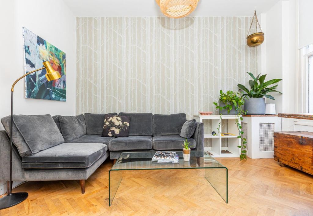 a living room with a couch and a table at Stunning 2BR Apt wPatio in Dalston, 2 min to Tube in London