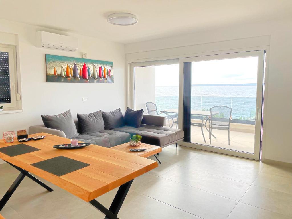 a living room with a couch and a table at Sea view Mandre in Mandre