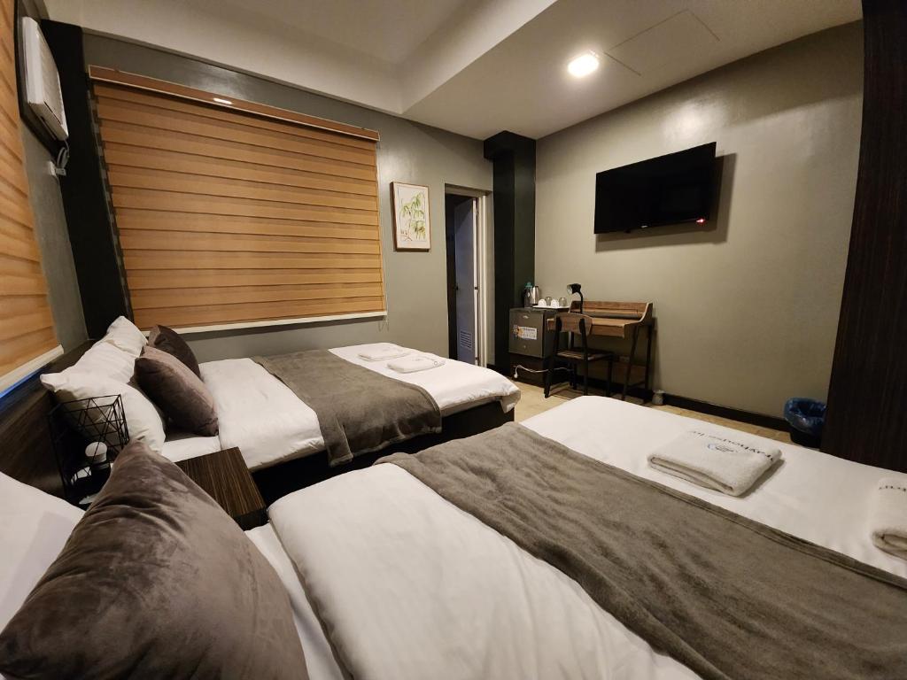 Postel nebo postele na pokoji v ubytování Grayhouse Inn Tagaytay
