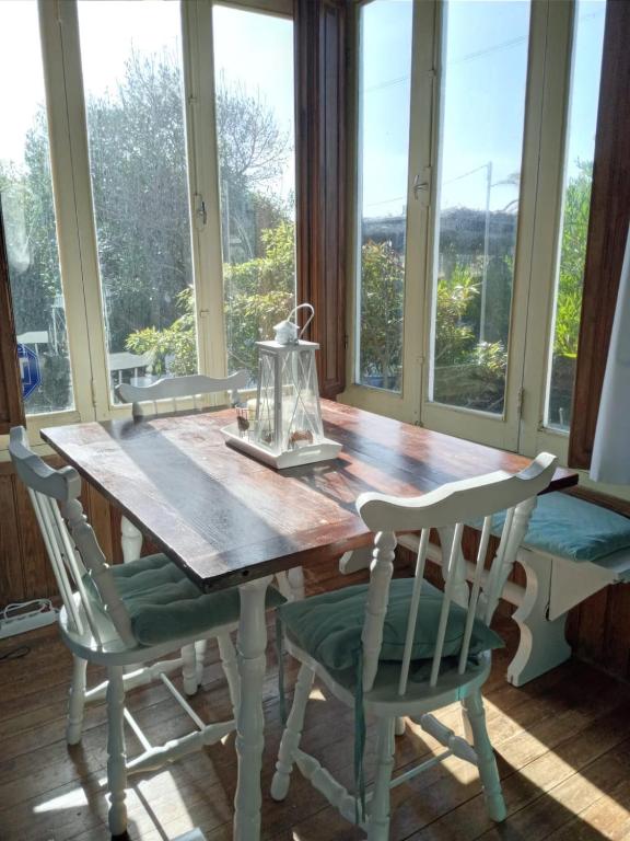 a dining room table with two chairs and a window at La Cabaña de Vito in La Paloma