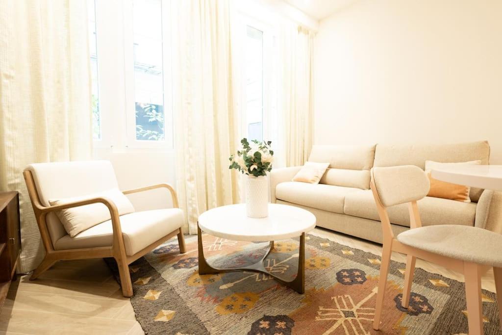 a living room with a couch and a table and chairs at New Luxury apartment - 4 people in Paris