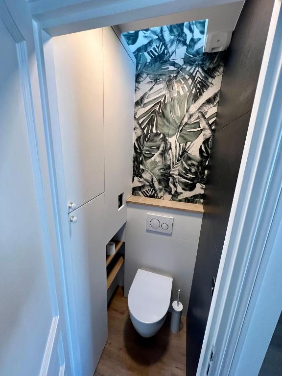 a bathroom with a white toilet in a room at Rooms with fabulous view on Paris roofs in Paris