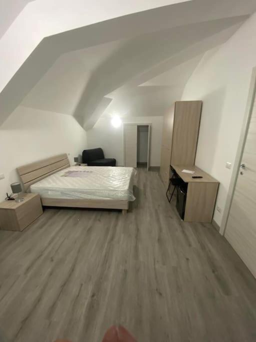 a bedroom with a bed and a desk in a room at Camera Quadrupla 3 Civitanova Marche in Civitanova Marche