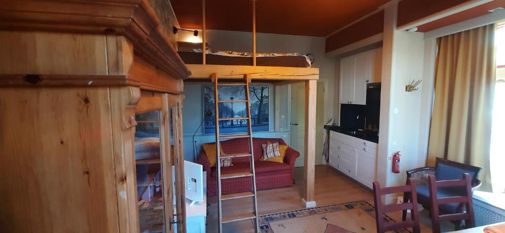 a room with a bunk bed and a living room at B & B De Groene Slaper in Silvolde