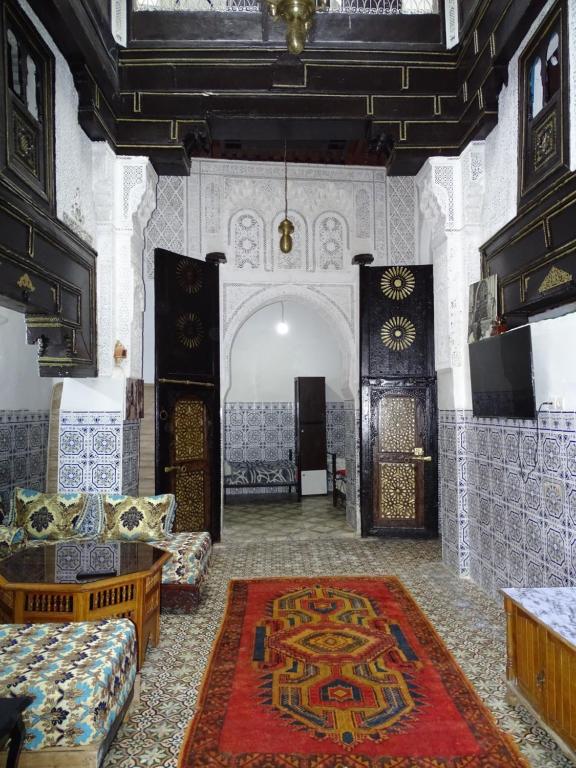 a room with two couches and a rug at Riad Amimi Fes in Fez