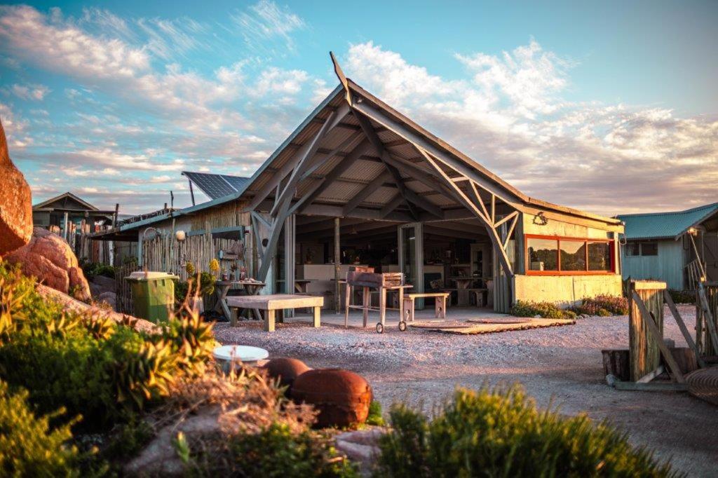 a house with a wooden roof with a patio at Sea Shack in Paternoster