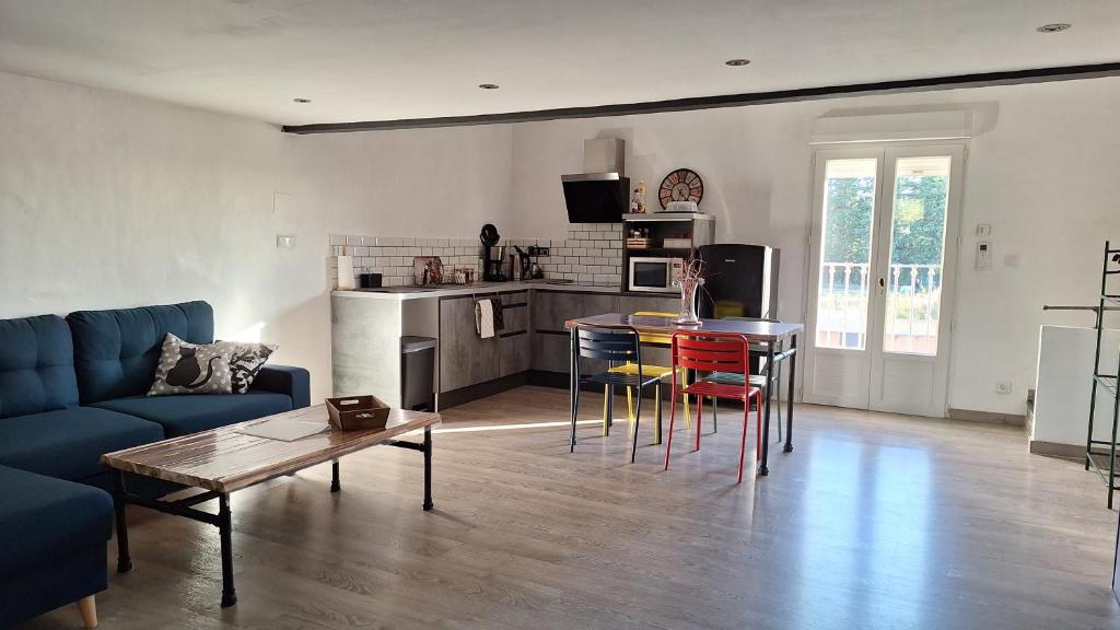 a living room with a couch and a table at Loft en duplex au Mas de la Restanque in Monteux