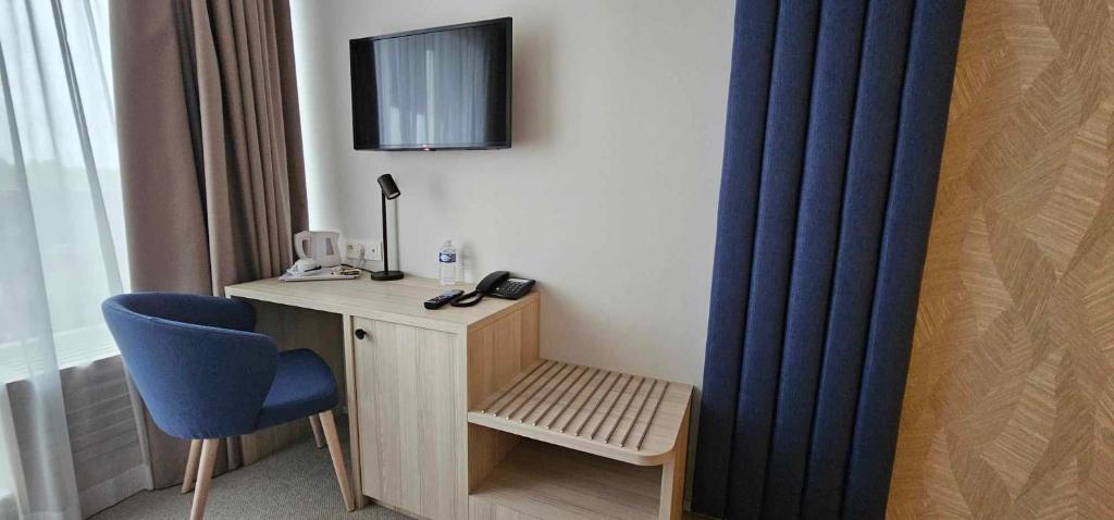 TV a/nebo společenská místnost v ubytování Hotel Les 3 Cles