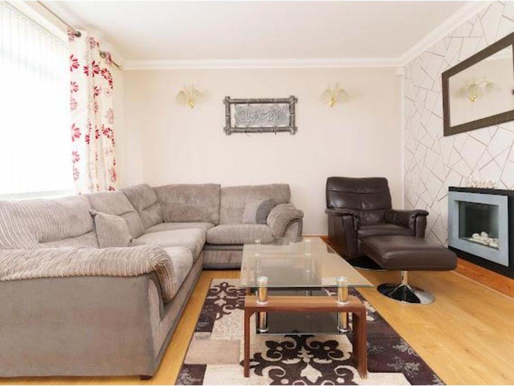 a living room with a couch and a table at Alexander House Apartments in Leeds