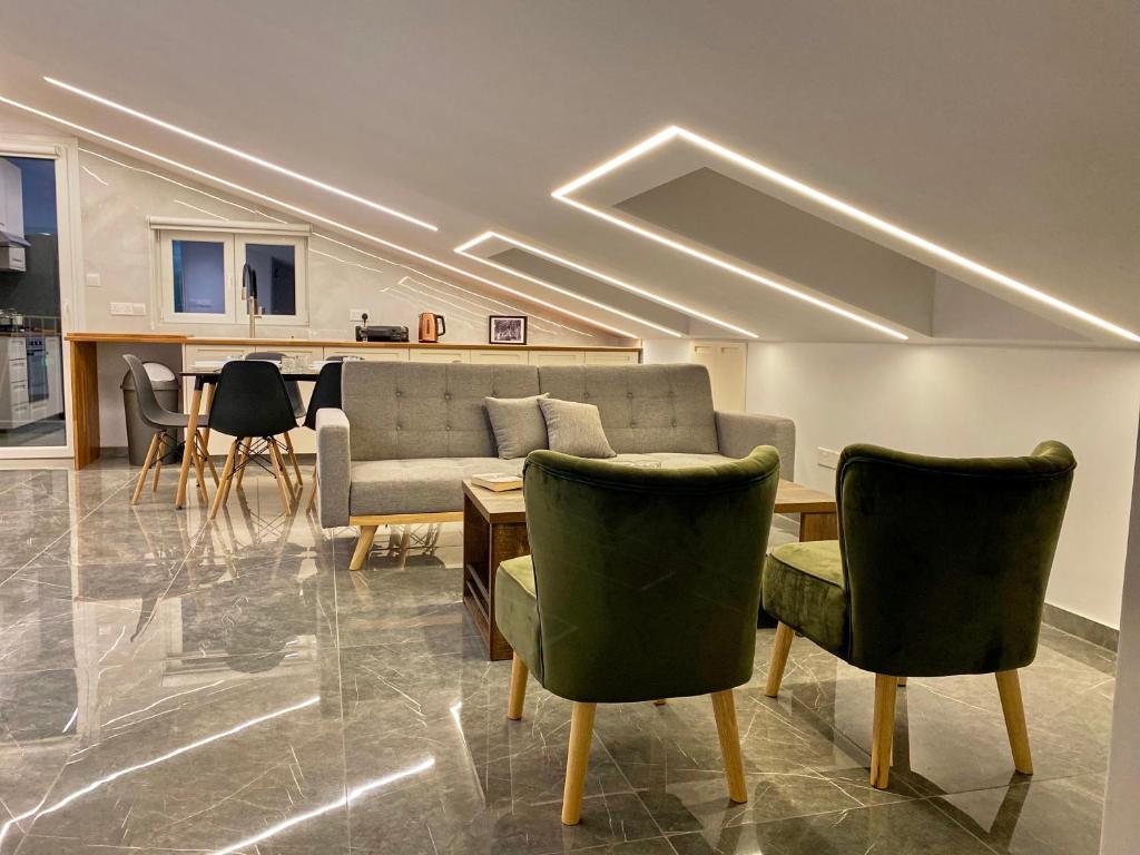 ein Wohnzimmer mit einem Sofa, einem Tisch und Stühlen in der Unterkunft Trendy Loft Apartment in Limassol