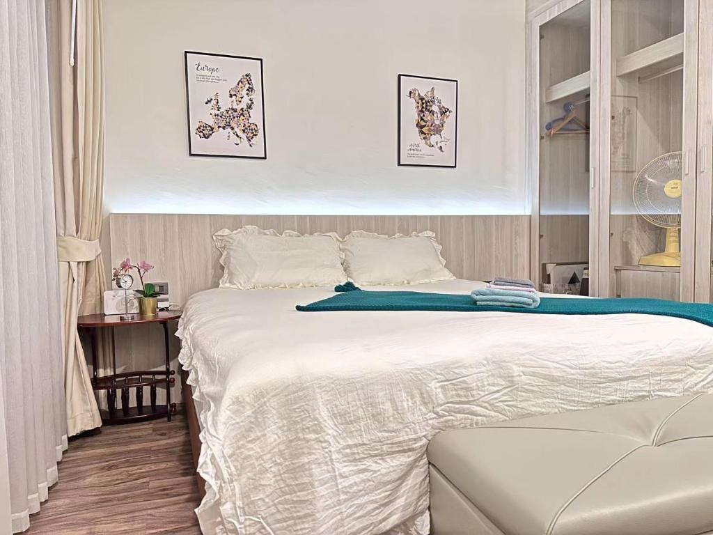 a bedroom with a large white bed in it at OCEANA HOME Phuket Kamala in Phuket Town