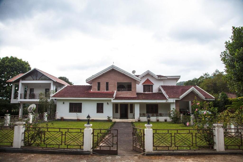 uma casa com um portão em frente em Pepper Vines Homestay em Chikmagalur