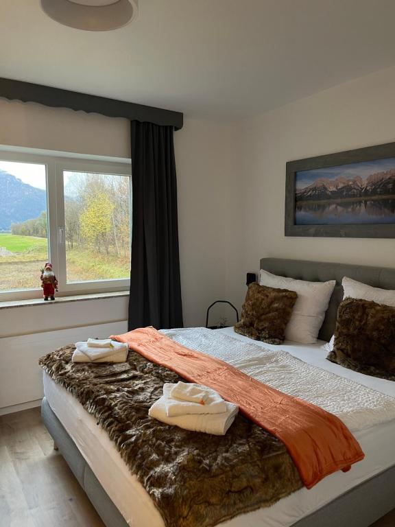 a bedroom with a bed with two towels on it at Gruppenhaus Alpenglück in Kirchdorf in Tirol