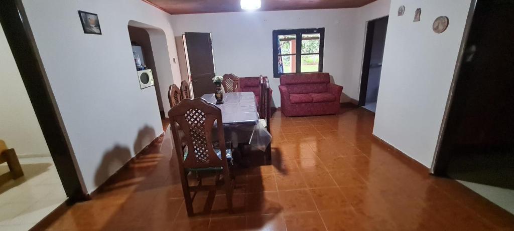 a living room with a table and a chair at Lo de Toty in Yapeyú