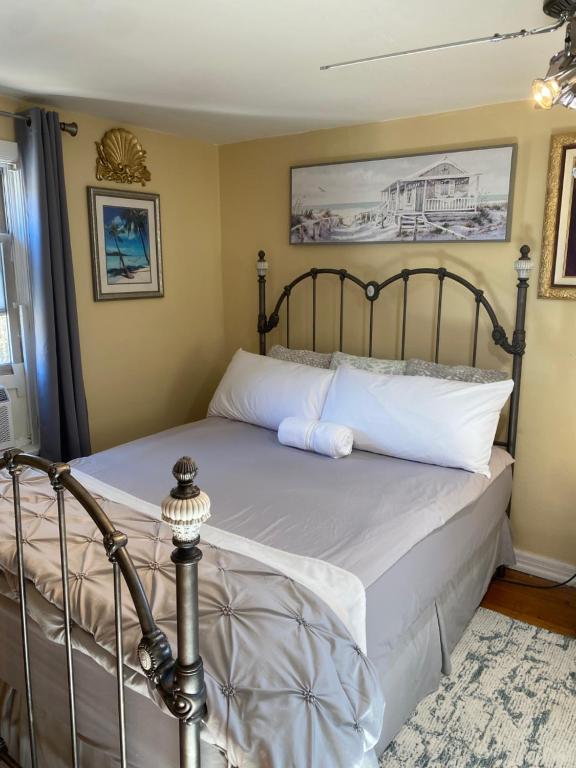 a bedroom with a bed with white pillows at Cozy room near Airport & Highway in Saint Louis