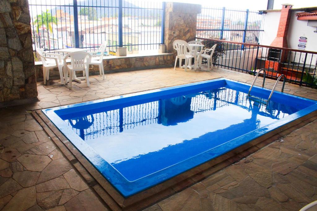 a swimming pool in the middle of a patio at Hotel São Charbel in Ubatuba