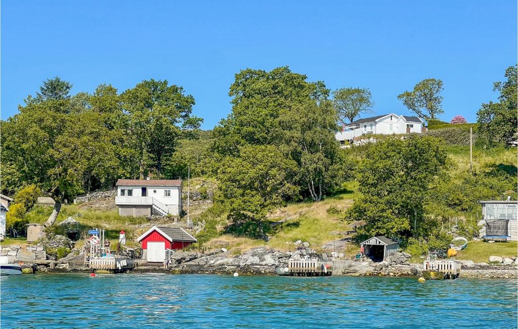 uma pequena ilha na água com casas em Beautiful Home In Rennesy With Wifi em Østhusvik