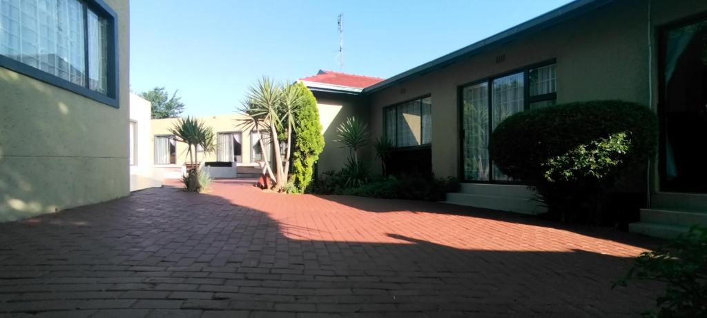a brick driveway in front of a house at Zwelibanzi Guesthouse in Johannesburg