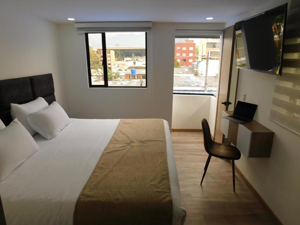 Postel nebo postele na pokoji v ubytování HOTEL MX BOGOTA