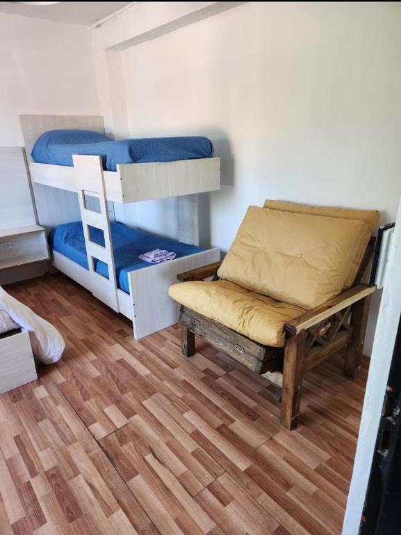 a room with two bunk beds and a bench at Rio Limay 1 in Neuquén