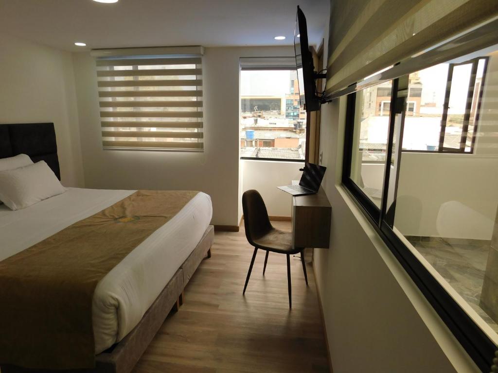 Postel nebo postele na pokoji v ubytování HOTEL MX BOGOTA