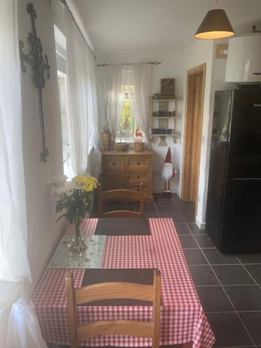 a kitchen with a table with a red and white checkered table cloth at The Potters Cottage in Clifden