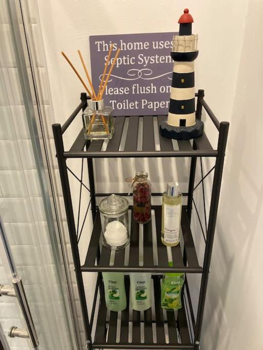 a shelf with soap and a lighthouse on it at The Potters Cottage in Clifden