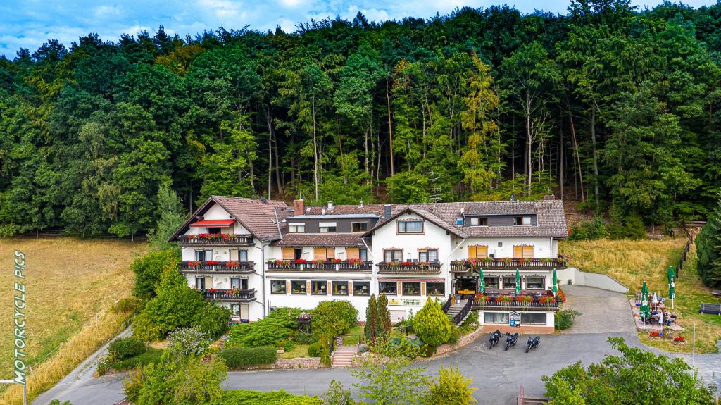 Gasthof-Hotel Lärmfeuer في Rohrbach: بيت ابيض كبير وسط غابه