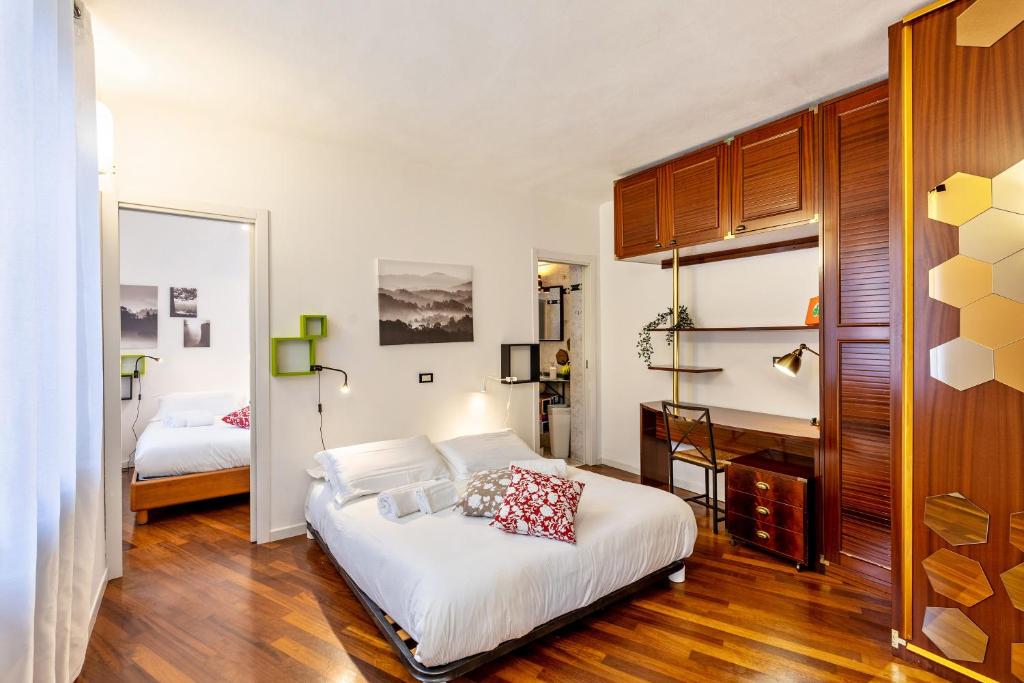 Schlafzimmer mit einem großen weißen Bett und Holzböden in der Unterkunft la vigna del Vescovo in Verona