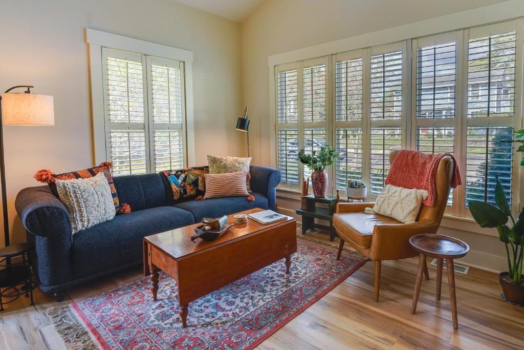 a living room with a blue couch and a table at Charming Granville Home with Porch - Walk Downtown! in Granville