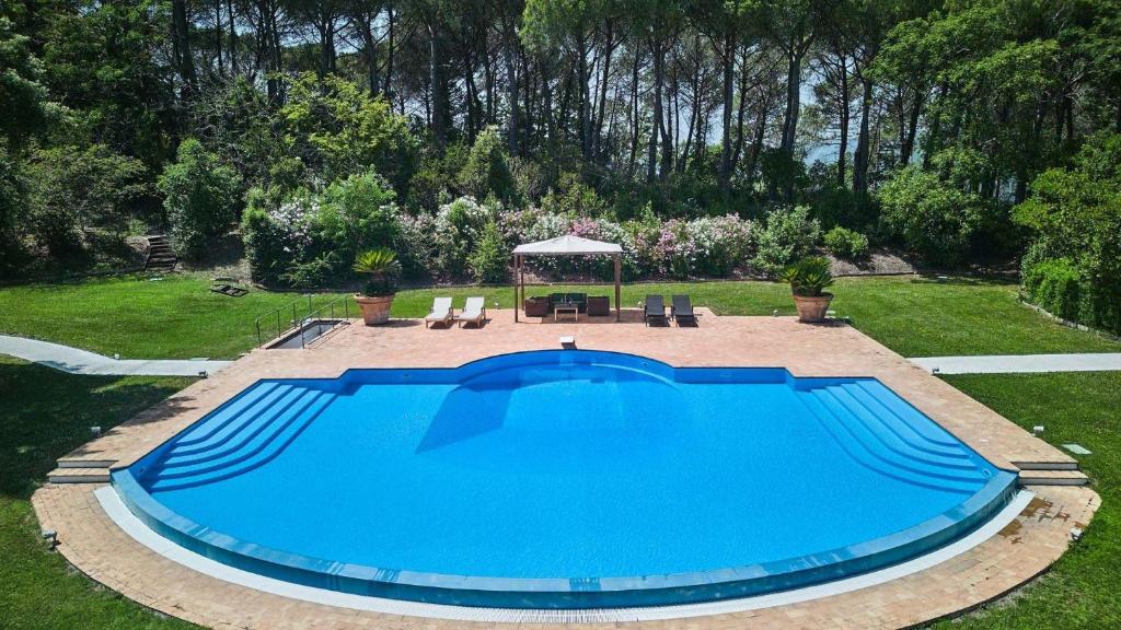 a large swimming pool in a yard with a gazebo at Belvedere in Castel Viscardo