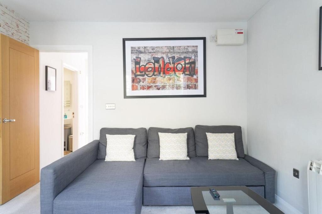 a living room with a couch and a table at Trendy & Central 2BD Flat -Brick Lane Shoreditch! in London