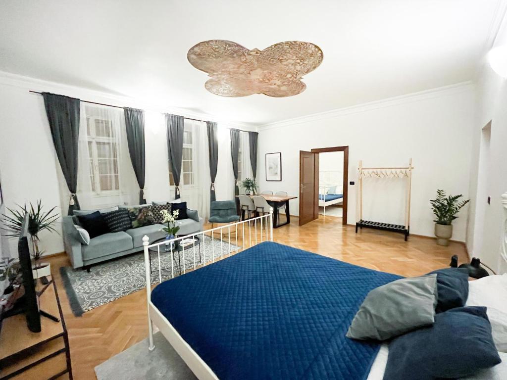 a bedroom with a bed and a living room at Best Price & Location - Historic Square Residency in Prague