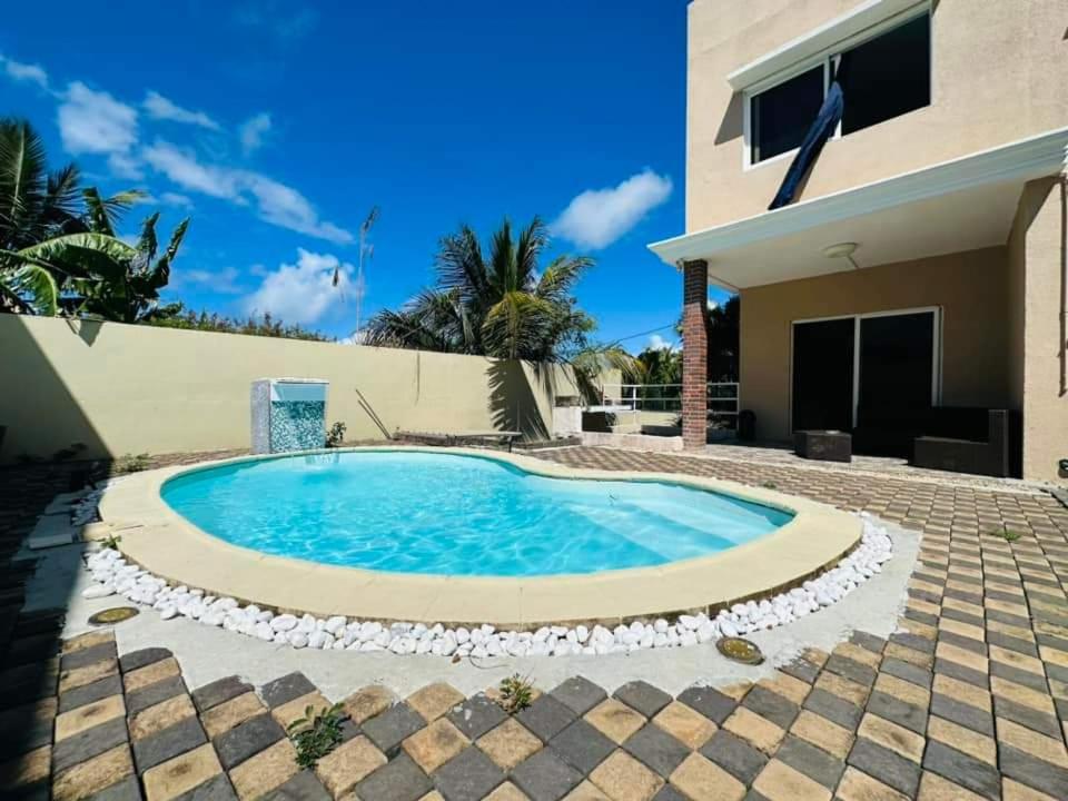 a swimming pool in front of a house at Villa Calodyne in Goodlands