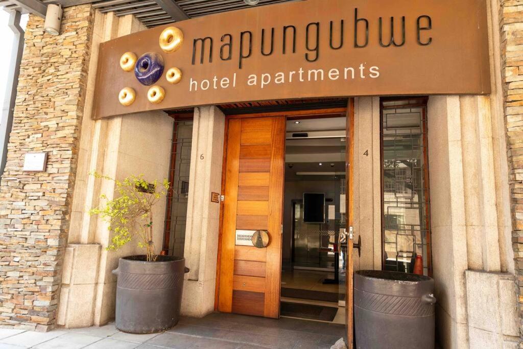 a building with a sign for a hotel apartments at Budget Friendly Private with WiFi 3km to Maboneng in Johannesburg