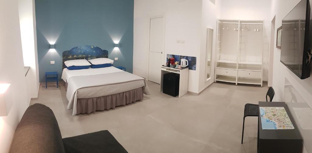 a bedroom with a bed and a living room at Partenope 10 in Naples