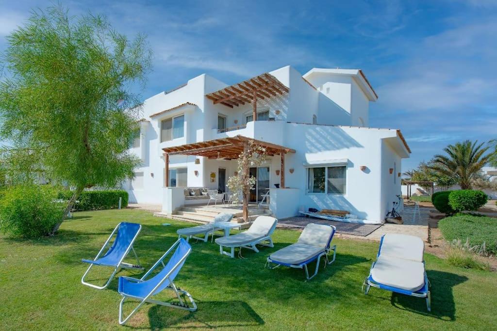 a villa with chairs and a house at unique flat_ garden and lagoon in Hurghada