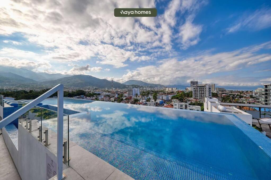 a swimming pool on the roof of a building at Amazing 1BR w/Rooftop Pool in Puerto Vallarta