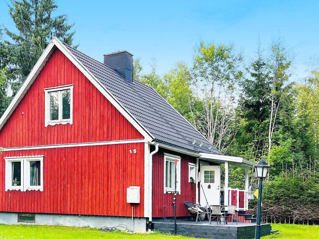 a red barn with a table and chairs in front of it at Holiday home Grängesberg in Grängesberg