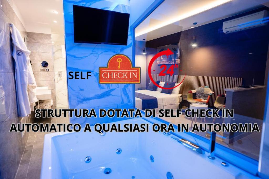 a bathroom with a tub and a tv in a room at Riverbed in Sarno