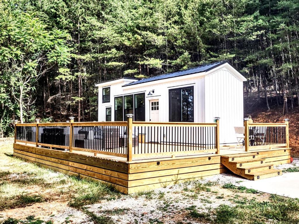 a tiny house with a large wooden deck at Tiny Home Big Fun in Knoxville