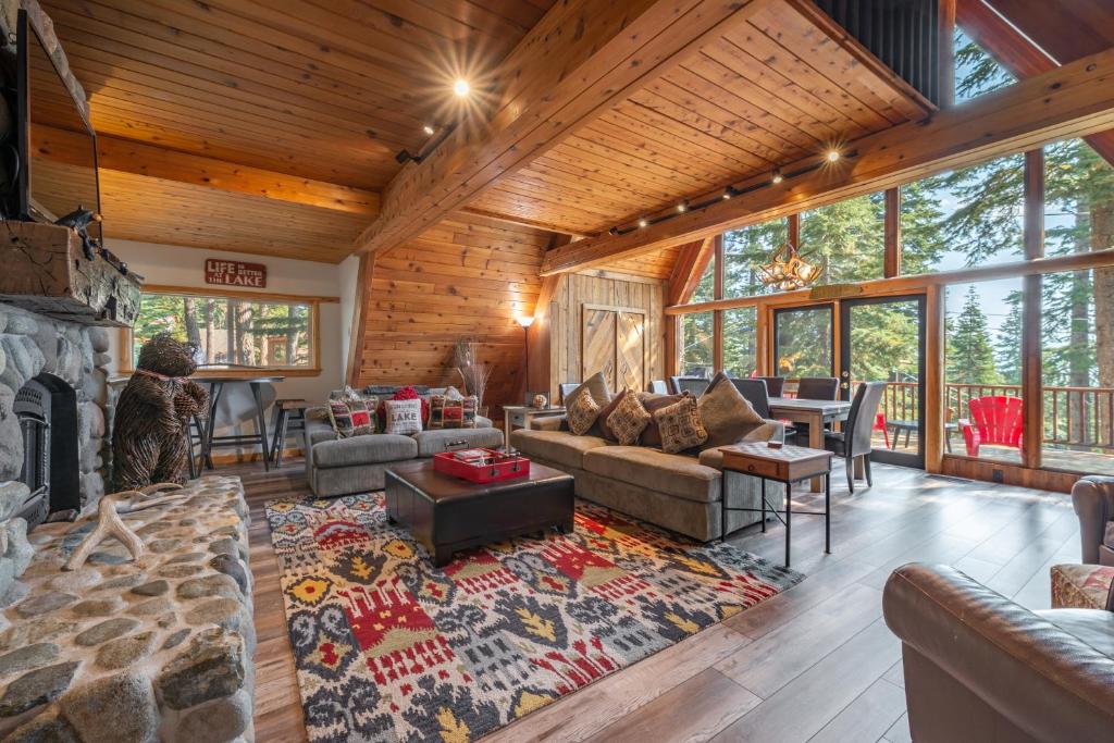 un soggiorno con divano e camino di Ember Ridge Retreat by Tahoe Getaways - 3BR Pet-Friendly Carnelian Bay Rental w Fenced Yard, Ping Pong, Hot Tub, Near Northstar a Carnelian Bay