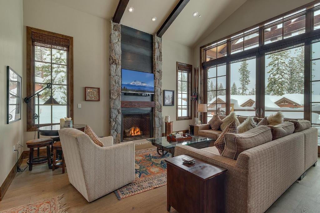a living room with a couch and a fireplace at Gondola Getaway- Ski-in Ski-out - Luxury 4 BR, Private Hot Tub, HOA Amenities in Truckee