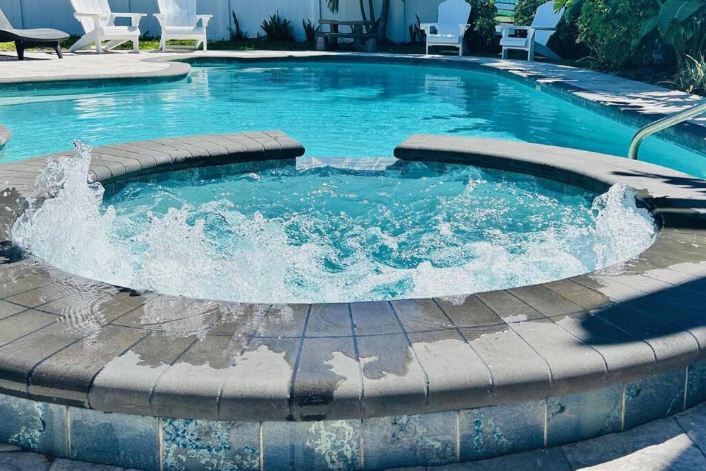 a pool with a fountain in the middle at Large pool! Ping Pong! 3 Bedrooms and 2 Bath! in Clearwater Beach