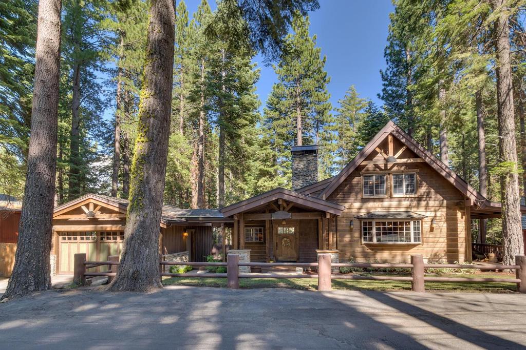 a log cabin in the woods with trees at Holly House on the West Shore - New Hot Tub, Wood Fireplace, Near Skiing in Tahoe City