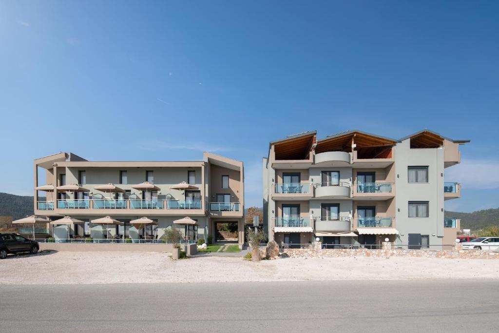 two buildings on the beach with a car parked in front at Vrahakia beach in Sarti