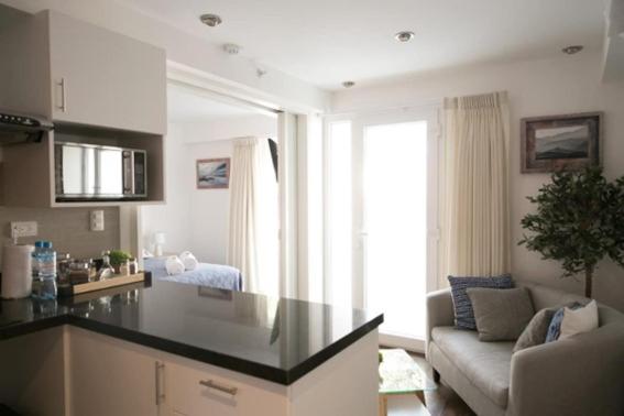 a kitchen with a counter top in a living room at Barranco Best Location - Apartment in Lima